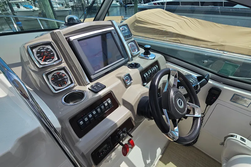 Slide: The Image of Control panel of a 2015 Chaparral 310 Signature boat with steering wheel and gauges. - 17