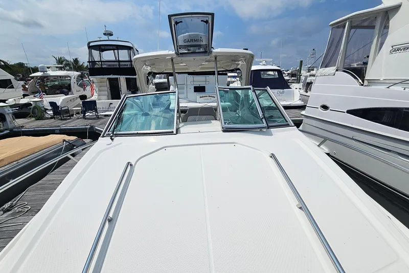 Slide: The Image of 2015 Chaparral 310 Signature boat docked among other yachts on a sunny day. - 24