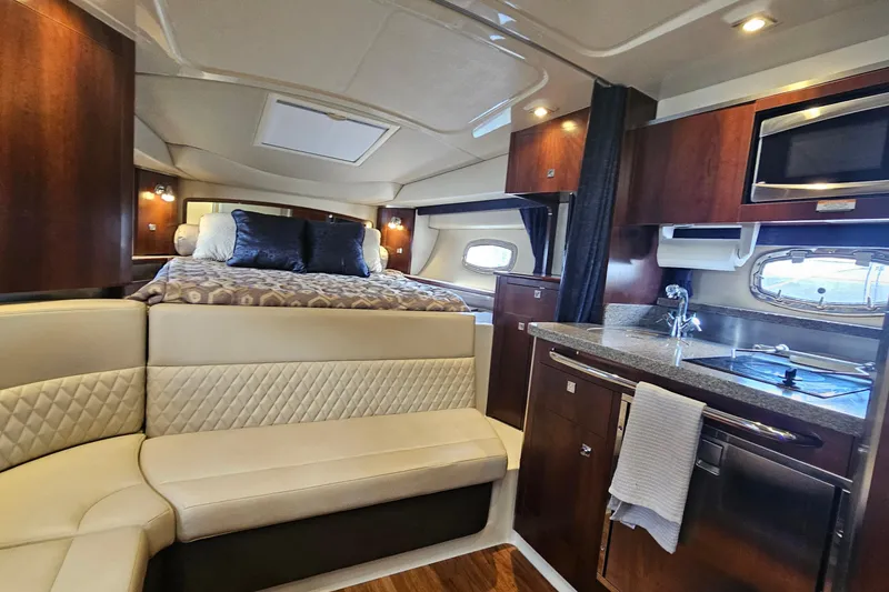 Slide: The Image of Luxurious interior of 2015 Chaparral 310 Signature yacht with kitchen and cozy seating area. - 27