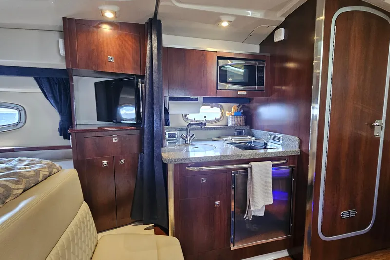 Slide: The Image of Luxurious interior of 2015 Chaparral 310 Signature yacht with modern kitchenette. - 29