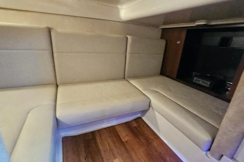 Slide: The Image of 2015 Chaparral 310 Signature interior with beige seating and wood flooring. - 31
