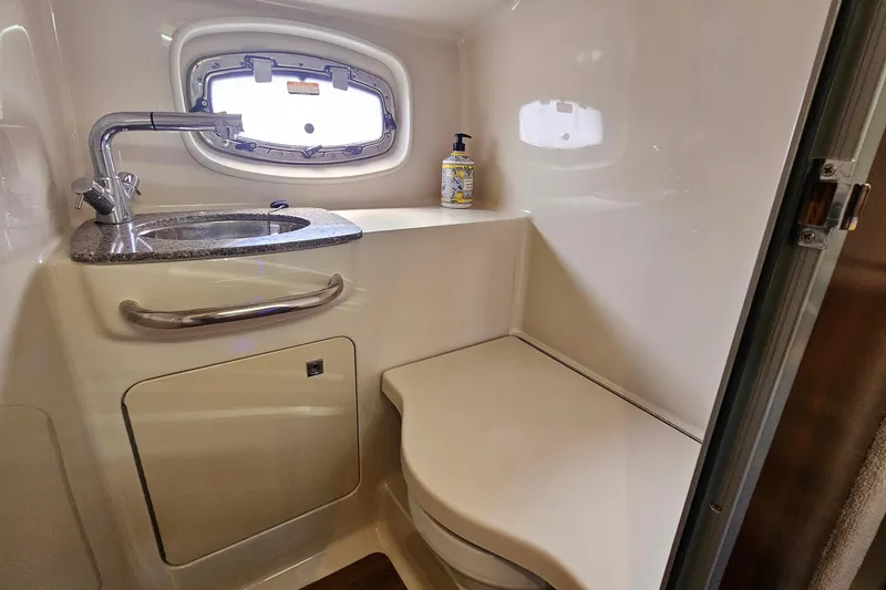 Slide: The Image of 2015 Chaparral 310 Signature boat bathroom with sink, window, and countertop. - 34