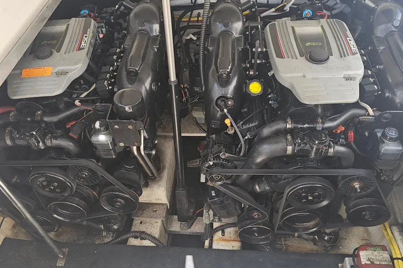 Slide: The Image of Engine compartment of a 2015 Chaparral 310 Signature boat, featuring dual MerCruiser engines. - 35