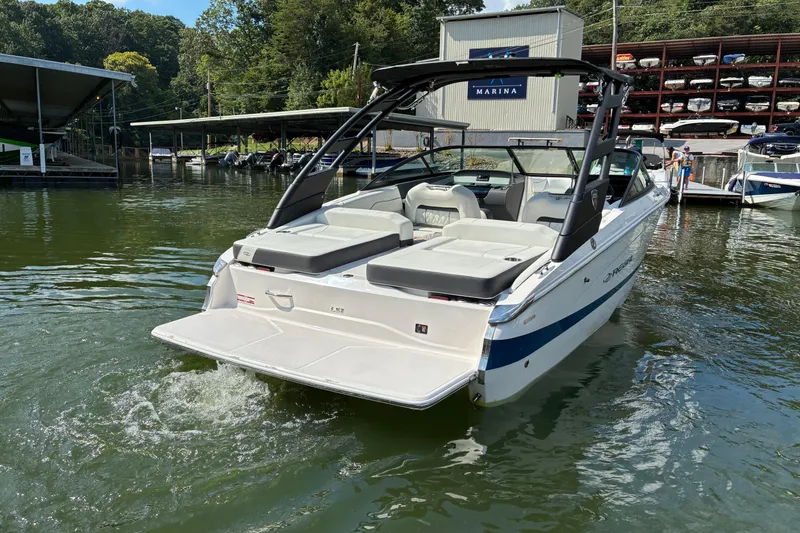 Slide: The Image of 2025 Regal LS2 boat docked at marina, featuring sleek design and spacious seating. - 10