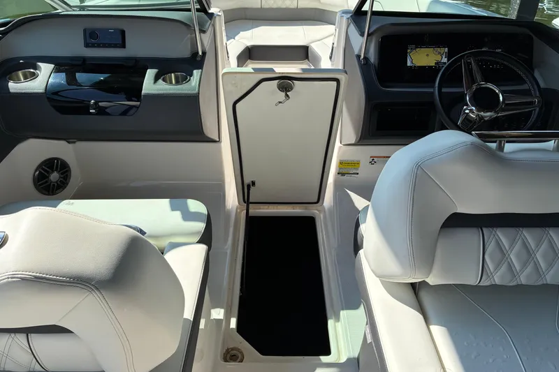Slide: The Image of Interior of 2025 Regal LS2 boat with modern dashboard and seating. - 12