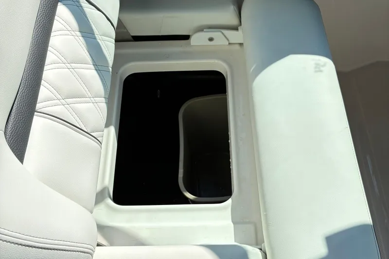 Slide: The Image of 2025 Regal LS2 boat seat storage compartment, open with visible interior space. - 13
