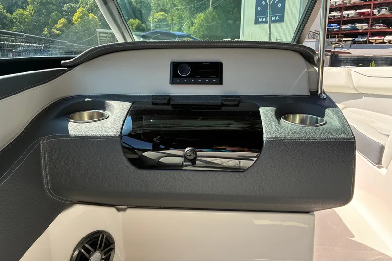 Slide: The Image of 2025 Regal LS2 boat interior with cup holders and control panel. - 14