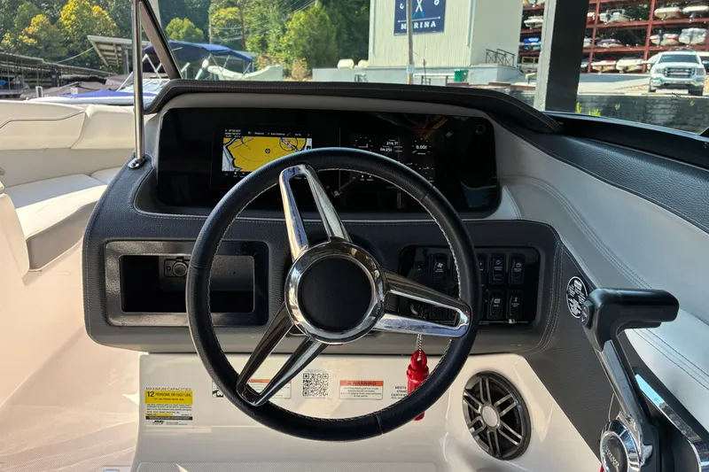 Slide: The Image of 2025 Regal LS2 boat dashboard with steering wheel and navigation display. - 15