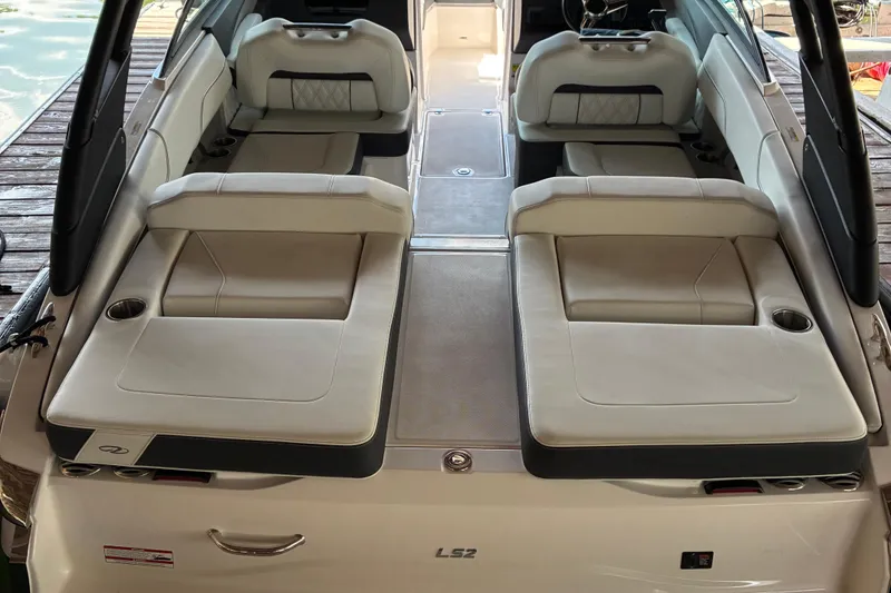 Slide: The Image of 2025 Regal LS2 boat interior with luxurious seating and cup holders. - 16