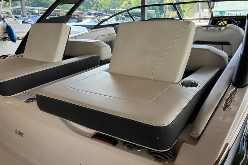 Slide: The Image of 2025 Regal LS2 boat interior with luxurious seating and cup holders. - 20