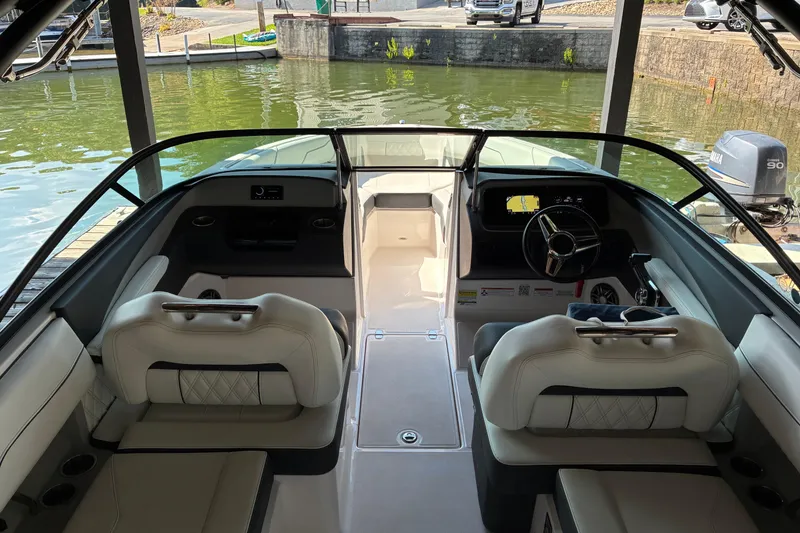 Slide: The Image of Interior view of 2025 Regal LS2 boat, featuring modern seating and dashboard. - 21