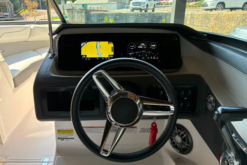 Slide: The Image of 2025 Regal LS2 boat dashboard with steering wheel and digital display. - 30