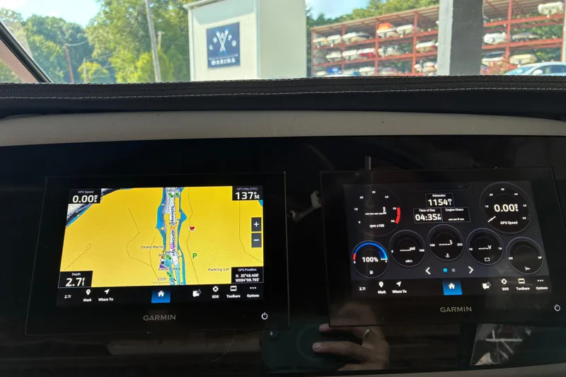 Slide: The Image of Dashboard of a 2025 Regal LS2 boat with Garmin navigation displays. - 32
