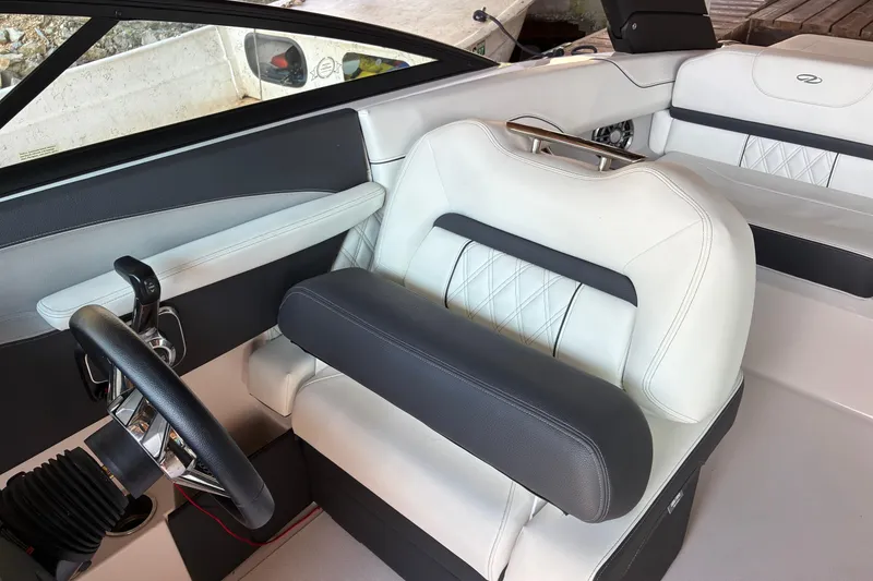 Slide: The Image of Interior of 2025 Regal LS2 boat with luxurious white and black seating. - 33