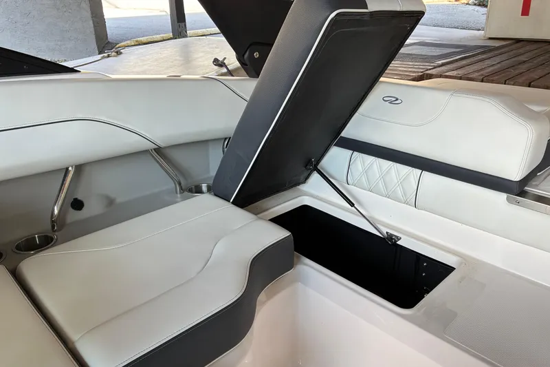 Slide: The Image of 2025 Regal LS2 boat interior with open storage compartment and luxurious seating. - 37