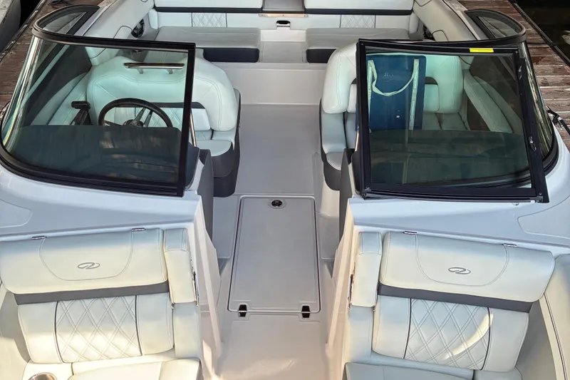 Slide: The Image of 2025 Regal LS2 boat interior with luxurious white seating and sleek design. - 39