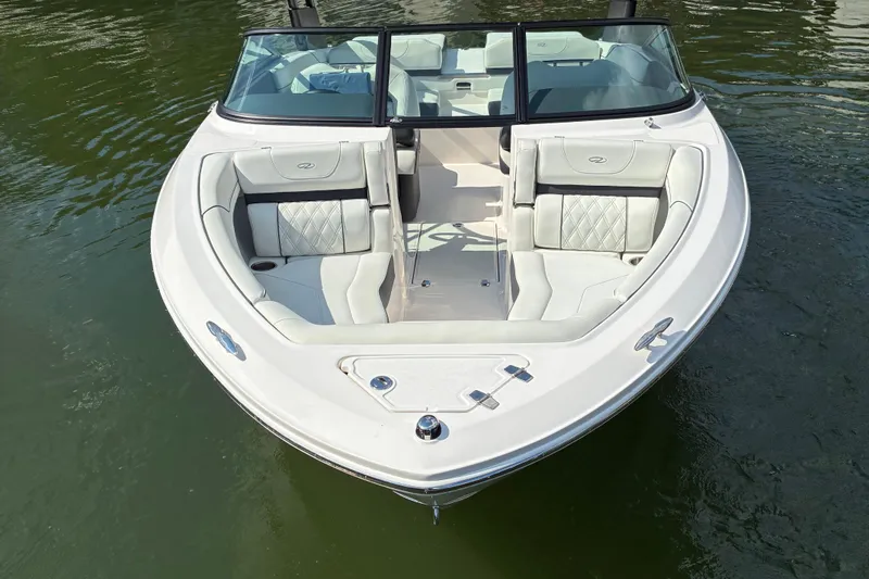 Slide: The Image of 2025 Regal LS2 boat with sleek white interior on calm water. - 4