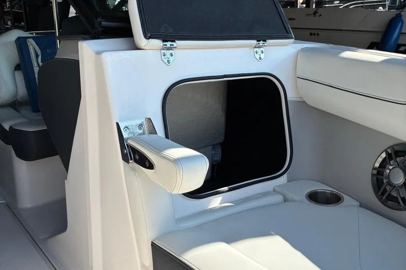 Slide: The Image of 2025 Regal LS2 boat interior with open storage compartment and speaker. - 44