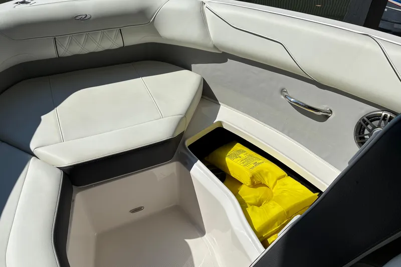 Slide: The Image of 2025 Regal LS2 boat interior with storage compartment and yellow life jackets. - 45
