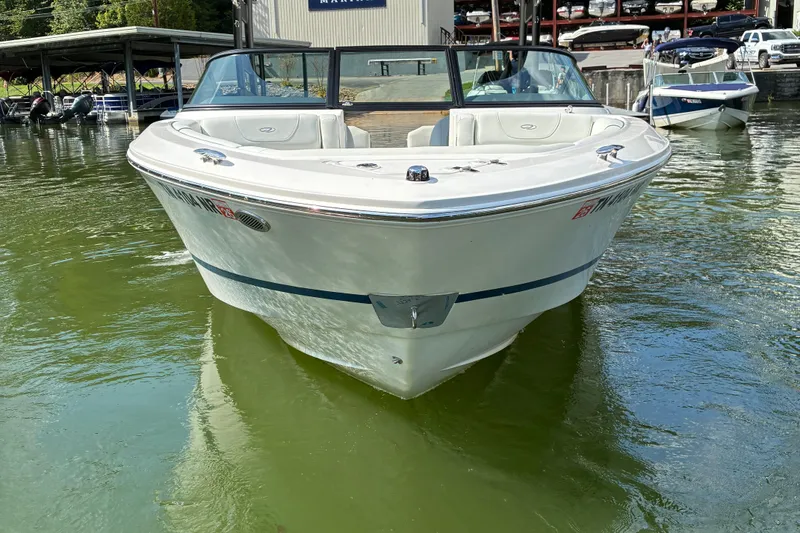 Slide: The Image of 2025 Regal LS2 boat docked on calm water, showcasing sleek design and modern features. - 5