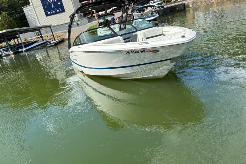 Slide: The Image of 2025 Regal LS2 boat cruising near marina, reflecting on calm water. - 6