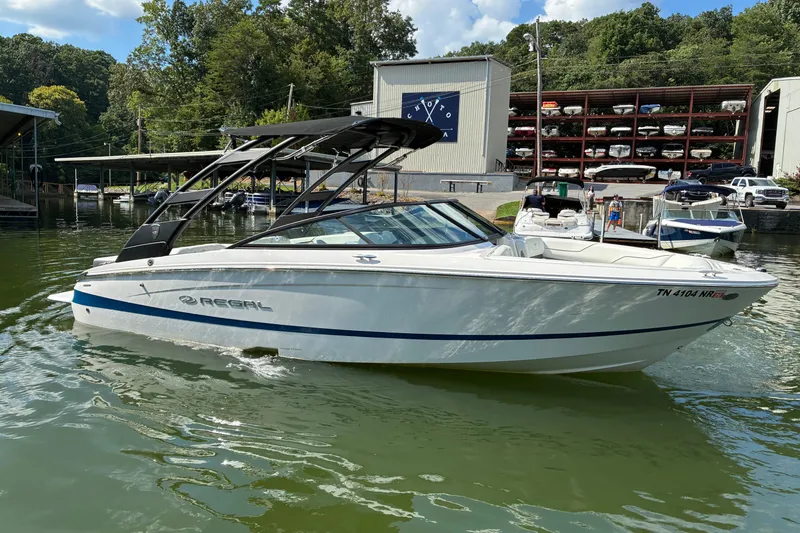 Slide: The Image of 2025 Regal LS2 boat docked on a sunny day at a marina. - 8