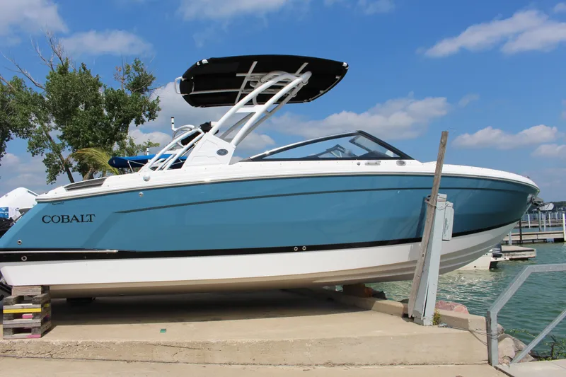 The Image of 2025 Cobalt R8 boat docked by the water on a sunny day. - 0