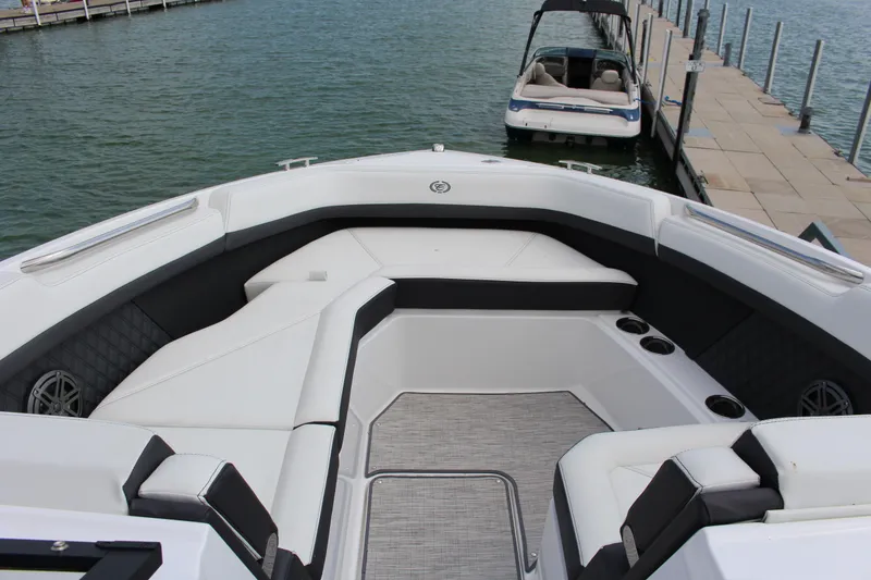 Slide: The Image of Luxurious 2025 Cobalt R8 boat interior with spacious seating and cup holders at a dock. - 10