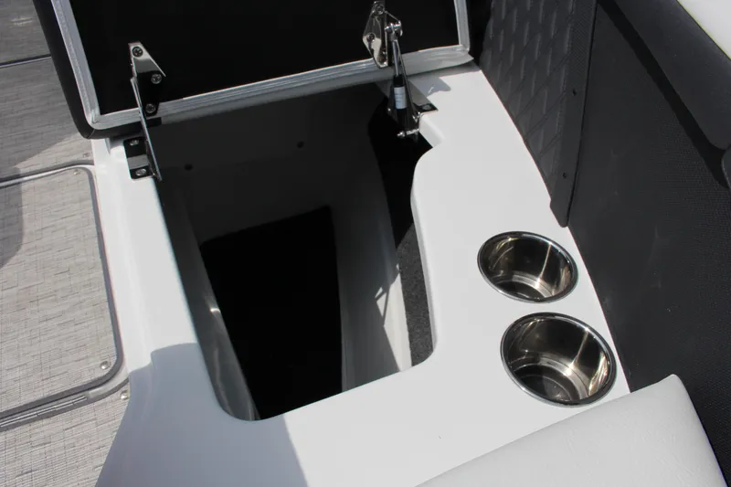 Slide: The Image of 2025 Cobalt R8 boat storage compartment with cup holders, open lid. - 15
