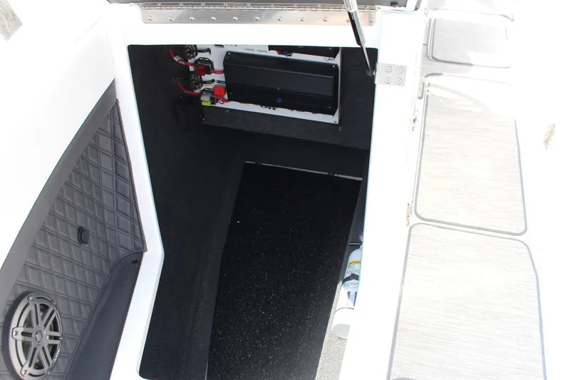 Slide: The Image of 2025 Cobalt R8 boat storage compartment with speaker and wiring details. - 16
