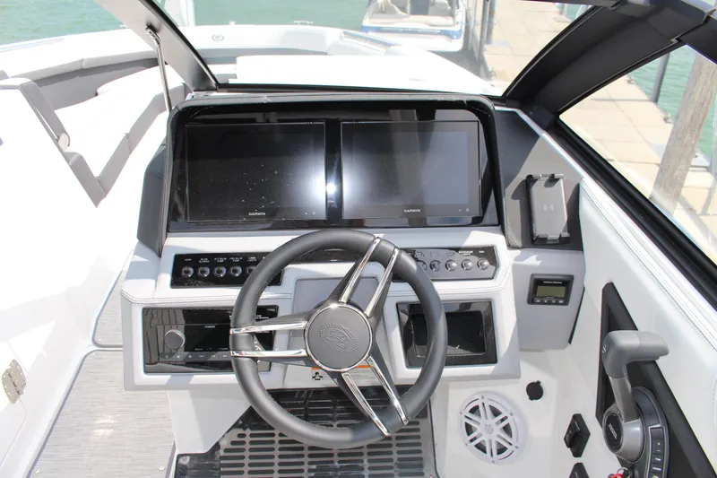 Slide: The Image of 2025 Cobalt R8 boat dashboard with dual screens and modern steering wheel. - 22