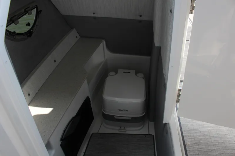 Slide: The Image of 2025 Cobalt R8 boat interior with compact portable toilet and storage space. - 29
