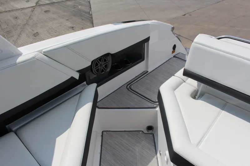 Slide: The Image of 2025 Cobalt R8 boat interior with white seating and integrated speaker system. - 31