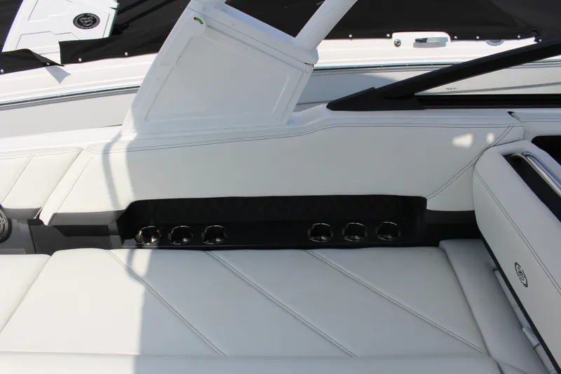 Slide: The Image of 2025 Cobalt R8 boat interior with white leather seating and integrated cup holders. - 33