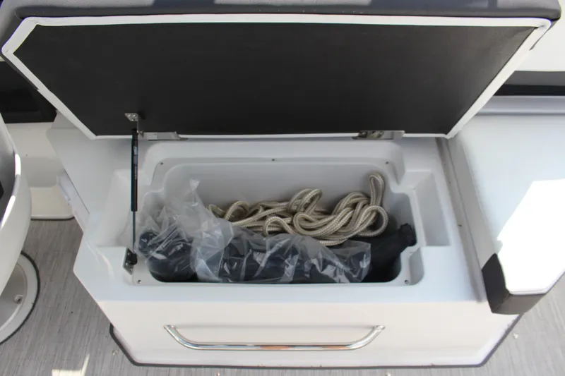 Slide: The Image of Open storage compartment in 2025 Cobalt R8 boat with rope and accessories. - 36