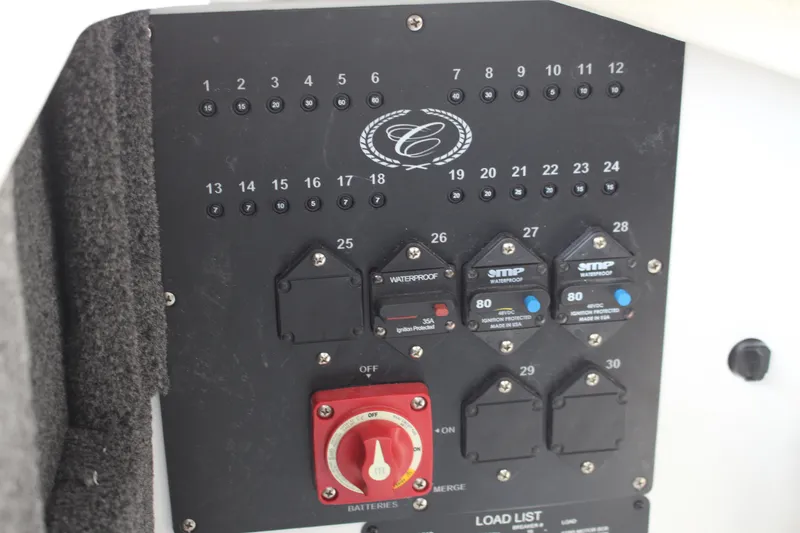 Slide: The Image of Control panel of a 2025 Cobalt R8 boat with switches and circuit breakers. - 38