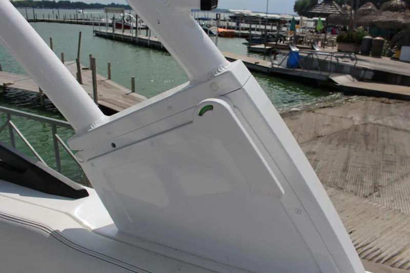 Slide: The Image of 2025 Cobalt R8 boat detail near dock with water and marina background. - 39