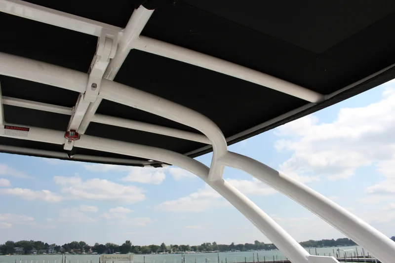 Slide: The Image of 2025 Cobalt R8 boat canopy structure with scenic lake view. - 40