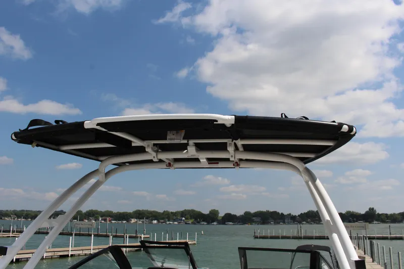 Slide: The Image of 2025 Cobalt R8 boat with a sleek canopy against a scenic lake backdrop. - 41