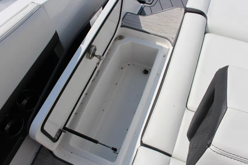 Slide: The Image of 2025 Cobalt R8 boat storage compartment with open lid, showcasing interior space. - 45