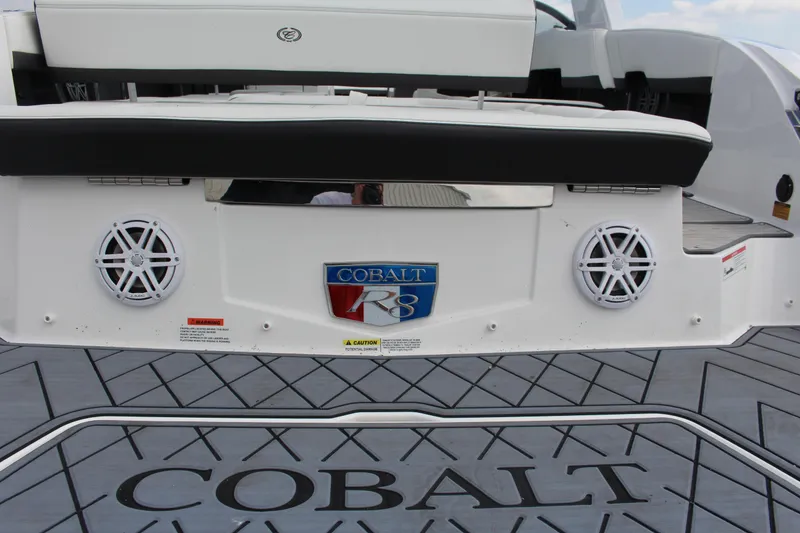 Slide: The Image of 2025 Cobalt R8 boat rear view with speakers and logo on deck. - 46
