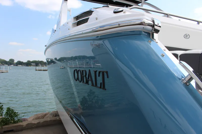 Slide: The Image of 2025 Cobalt R8 boat docked by a scenic lake. - 5