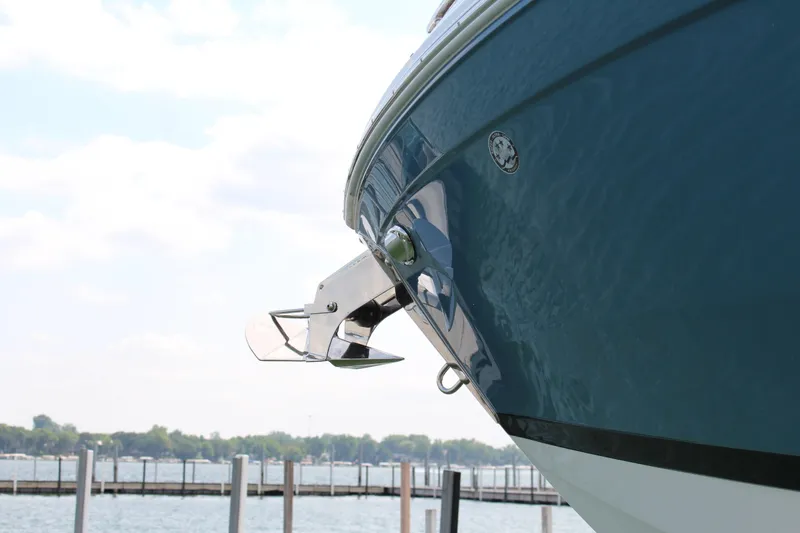 Slide: The Image of 2025 Cobalt R8 boat bow with stainless steel anchor, docked by a serene lake. - 6