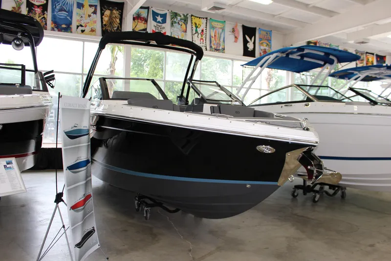 The Image of 2025 Cobalt R6 boat displayed in showroom with promotional stand. - 1
