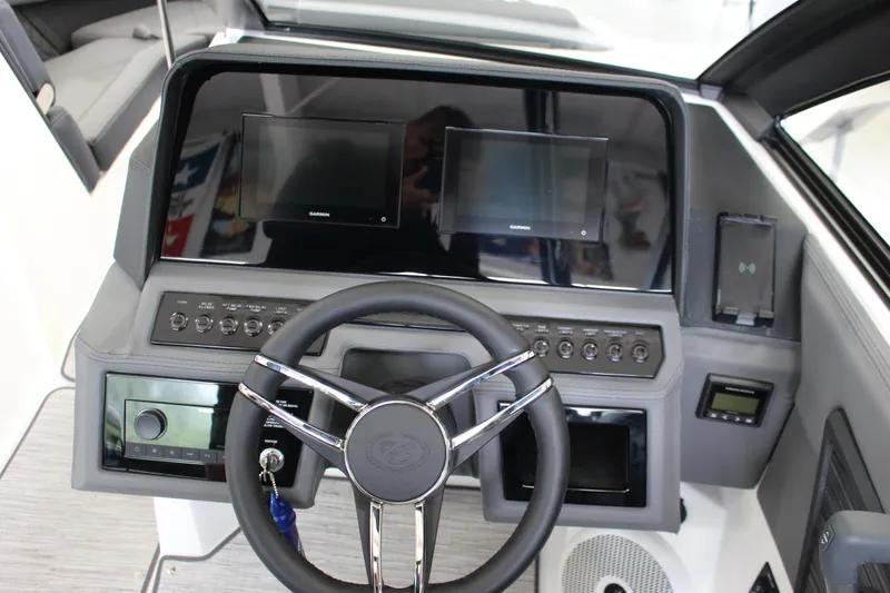 Slide: The Image of 2025 Cobalt R6 boat dashboard with steering wheel and digital displays. - 10