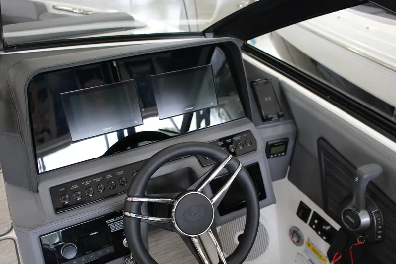 Slide: The Image of 2025 Cobalt R6 boat dashboard with dual Garmin displays and modern steering wheel. - 11