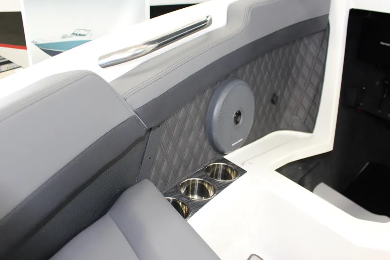 Slide: The Image of 2025 Cobalt R6 boat interior with quilted upholstery, speaker, and cup holders. - 13