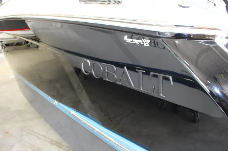 Slide: The Image of 2025 Cobalt R6 boat with sleek black exterior in a showroom setting. - 18