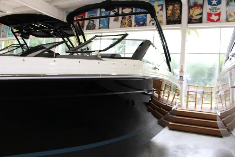 Slide: The Image of 2025 Cobalt R6 boat displayed indoors with sleek black and white design. - 3