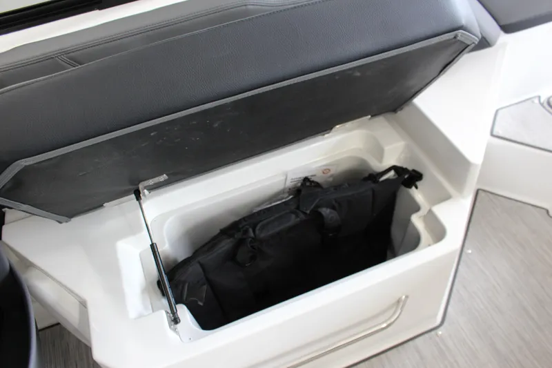 Slide: The Image of Open storage compartment in 2025 Cobalt R6 boat with black bag inside. - 6